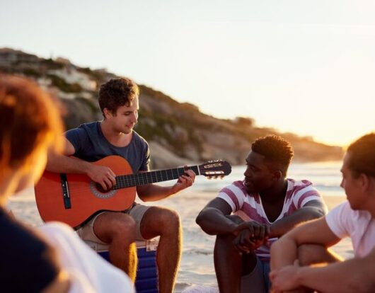 group-people-bonding-together-break-social-by-beach-holiday-vacation-picnic-friends-relax-fun-with-guitar-summer-season-wellness-outdoor-adventure-by-ocean-greece_590464-483846